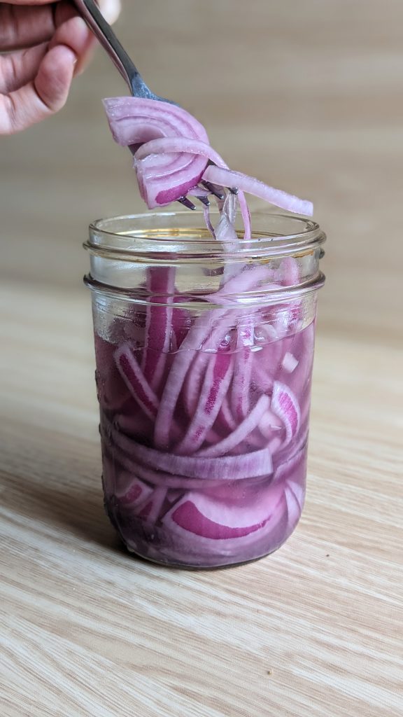 closeup of lactofermented red onions